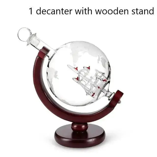 Whiskey Decanter Globe with sailboat design on a wooden stand.