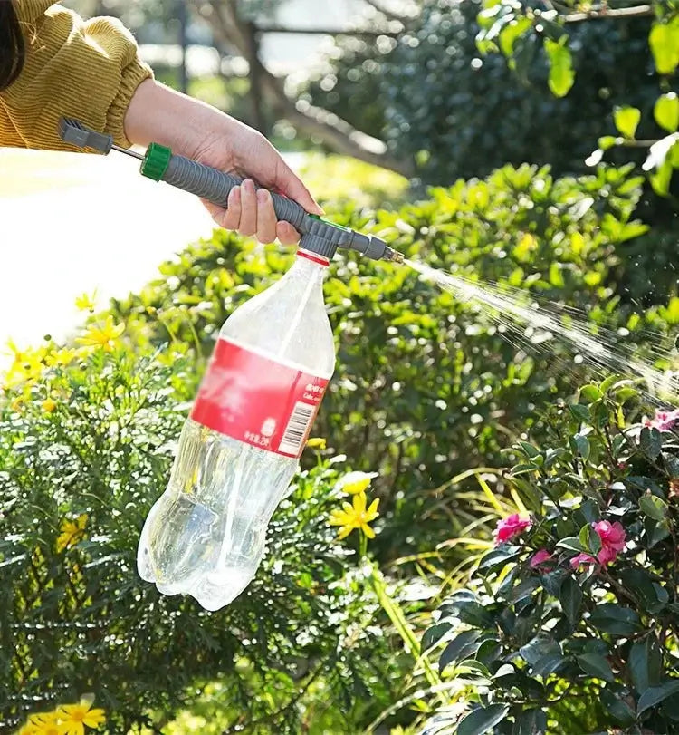 Beverage Bottle Sprayer in action, watering flowers in a garden, showcasing its multi-functional nozzle design.