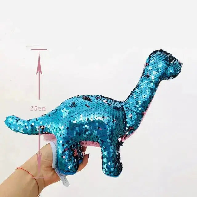 Sequin dinosaur color changing pillow toy in blue, held by a hand, standing 25 cm tall.