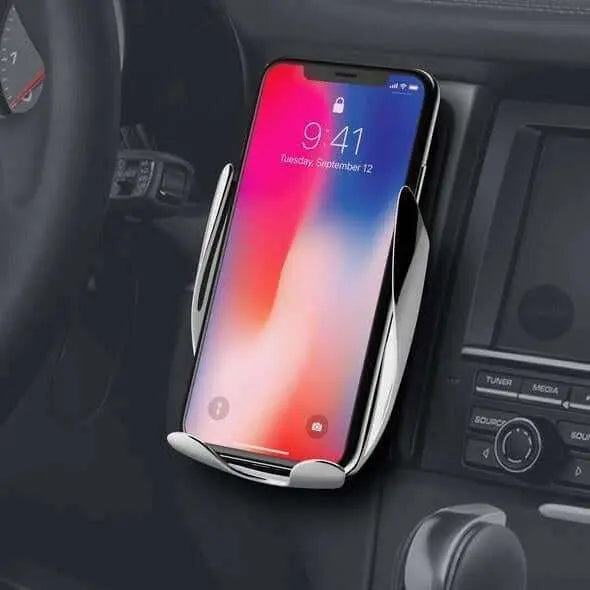 Automatic clamping wireless fast charging phone holder in car.