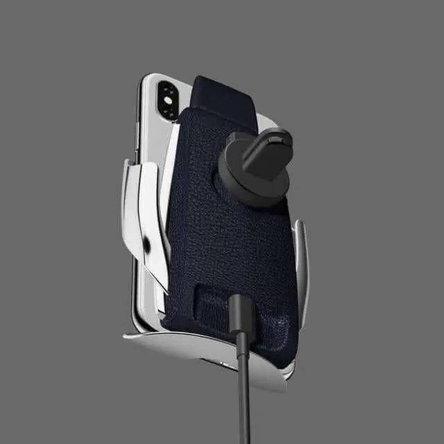 Automatic clamping wireless fast charging phone holder on gray background.