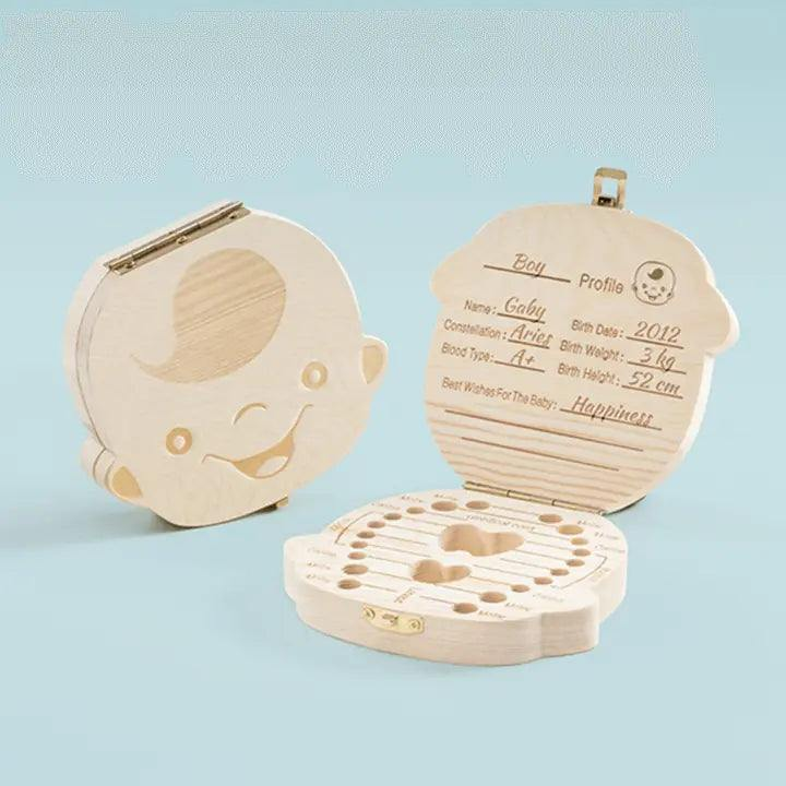 Baby wooden teeth organizer with engraved compartments on a light blue background.