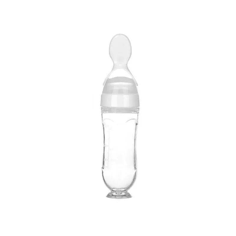 Baby squeezing feeding bottle with soft silicone spoon for easy feeding.