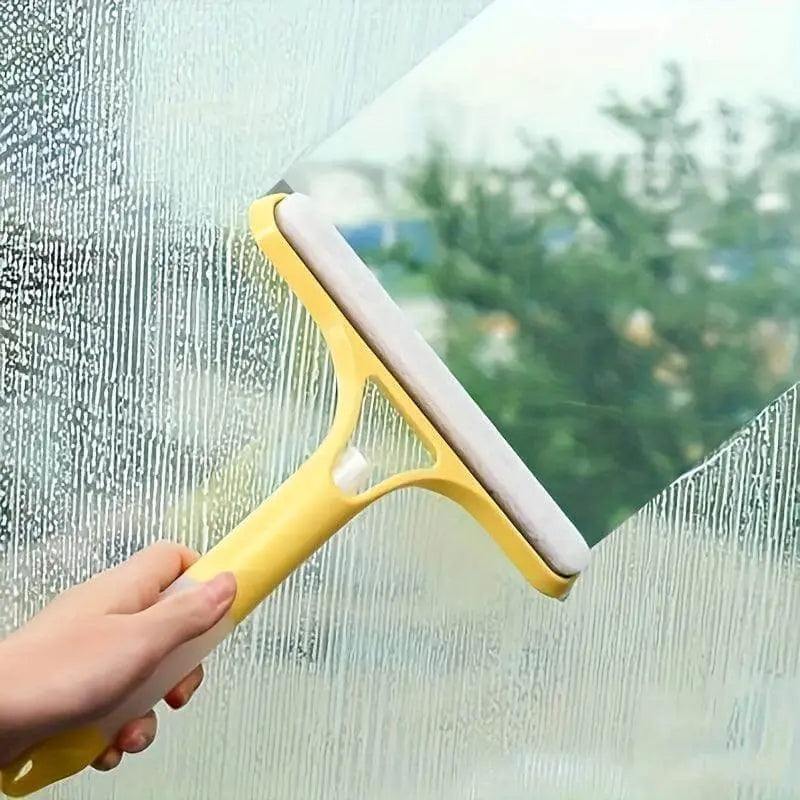Glass cleaner wiper with scraper in use on window for streak-free cleaning.