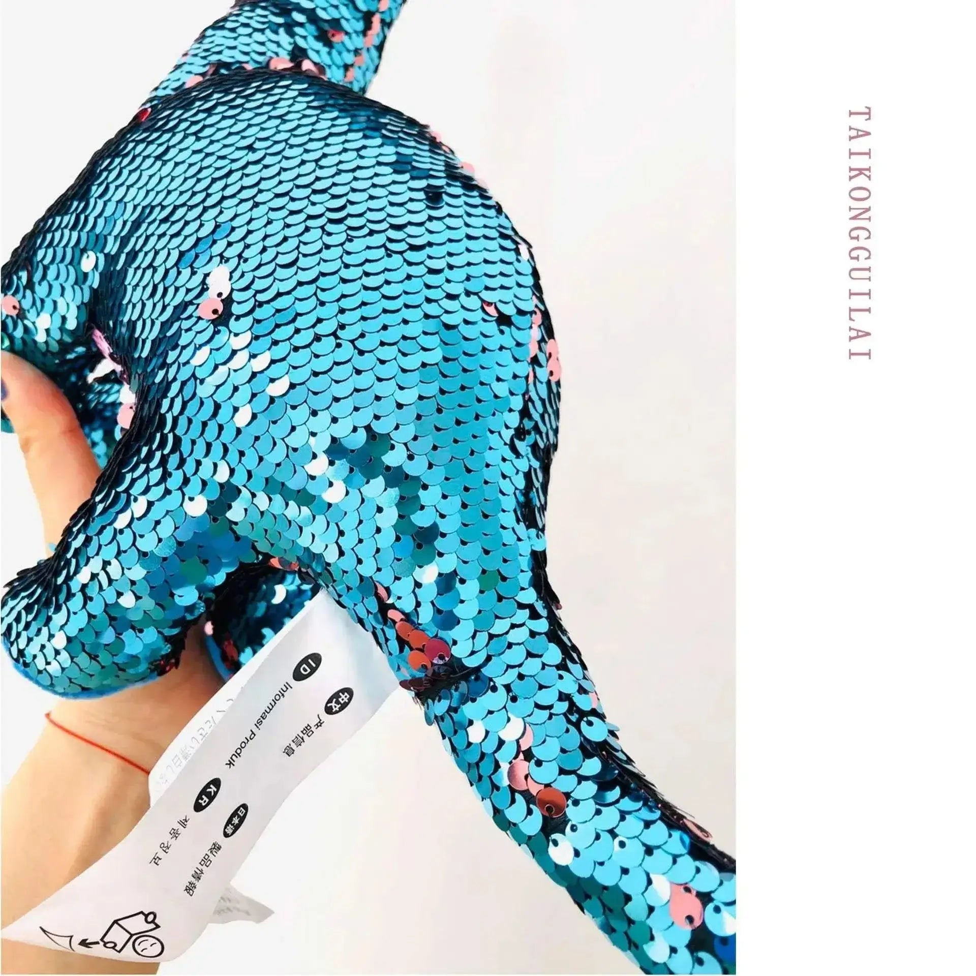 Sequin Dinosaur Color Changing Pillow Toy shimmering in blue.