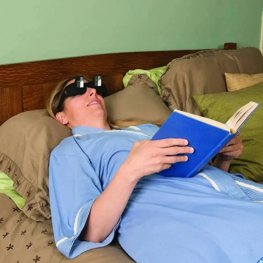 Woman using Lazy Prism Glasses while lying in bed, reading a book comfortably.