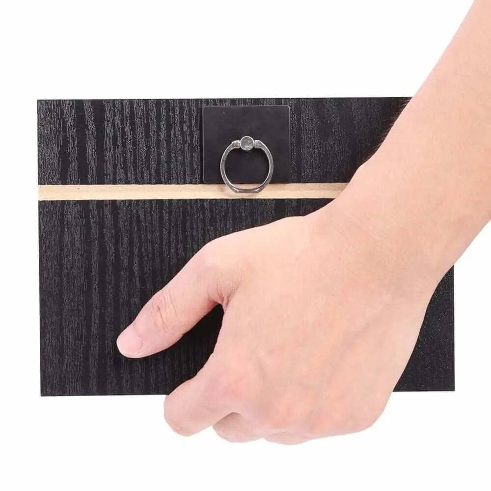Hand holding a portable mobile screen amplifier with a wooden finish.