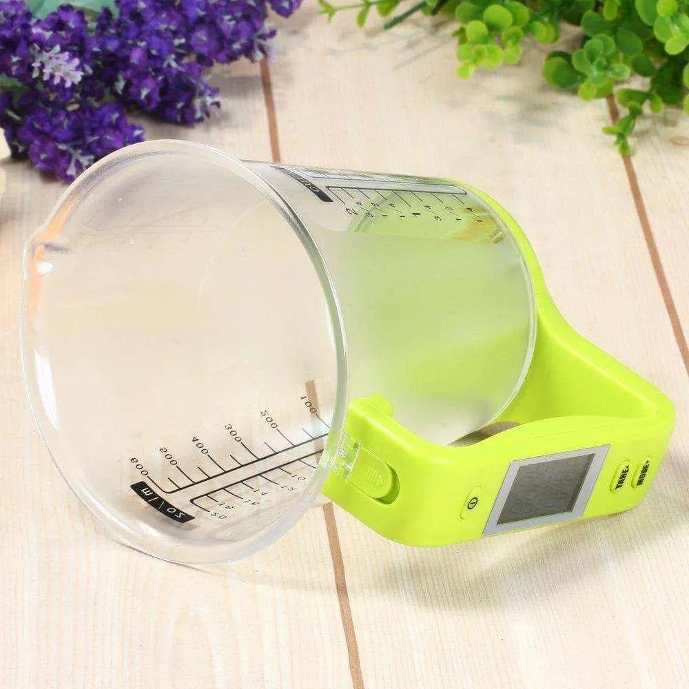 LCD Display Digital Measuring Cup on wooden surface, featuring built-in scale and temperature reading.