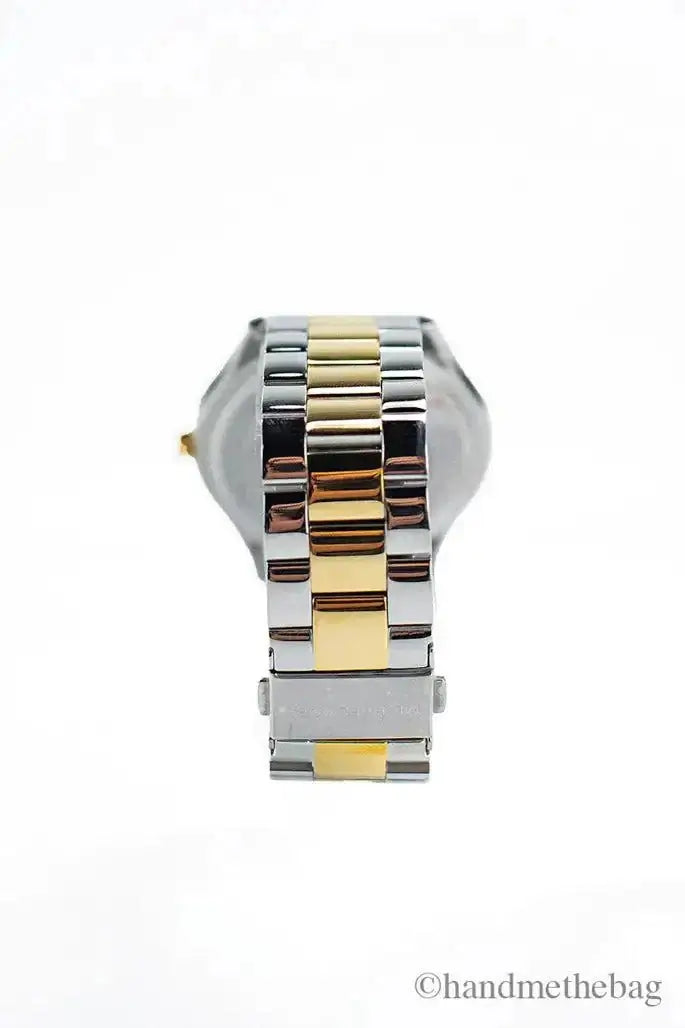 Michael Kors Slim Runway gold and silver toned stainless steel watch with stick indices and deployant closure.