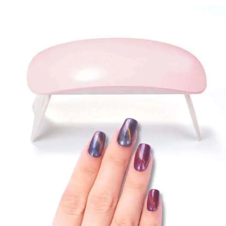 Mini Portable LED UV Nail Dryer with hand showcasing cured, polished nails.