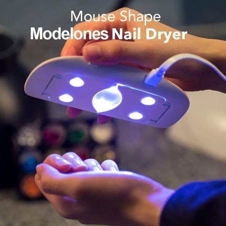 Mini Portable LED UV Nail Dryer curing hands under light.