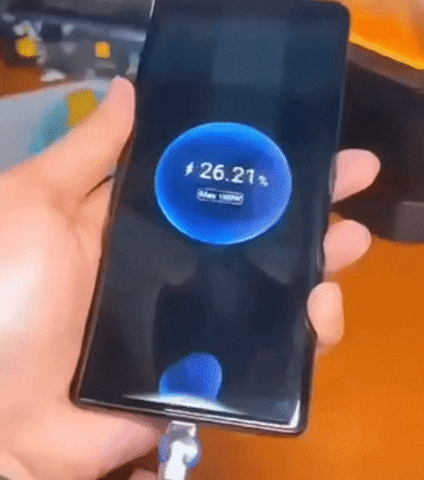 Magnetic charging cable connected to a phone, displaying fast charging in progress.