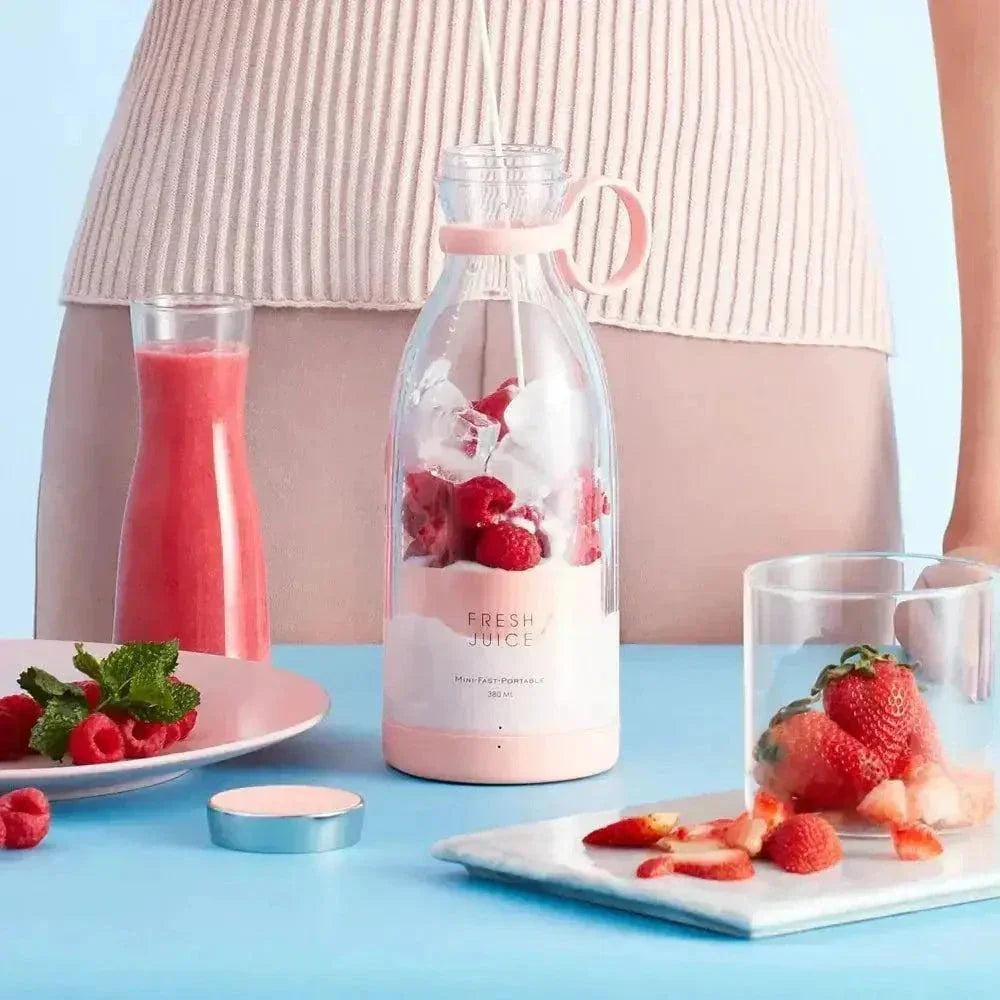 Portable fresh fruit blender with berries, compact and rechargeable for on-the-go blending.