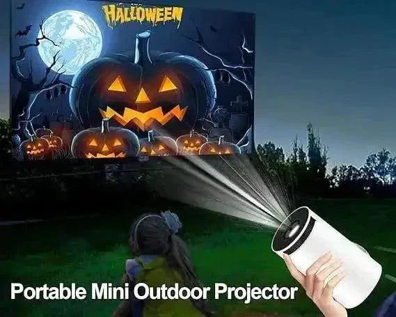 Mini portable projector projecting Halloween image outdoors in a park setting.