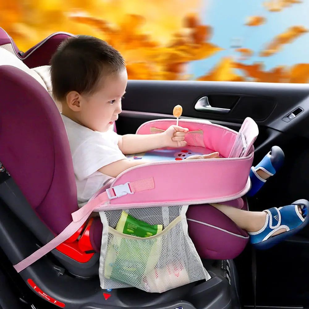 Toddler using portable waterproof baby car tray with storage pockets in car seat.