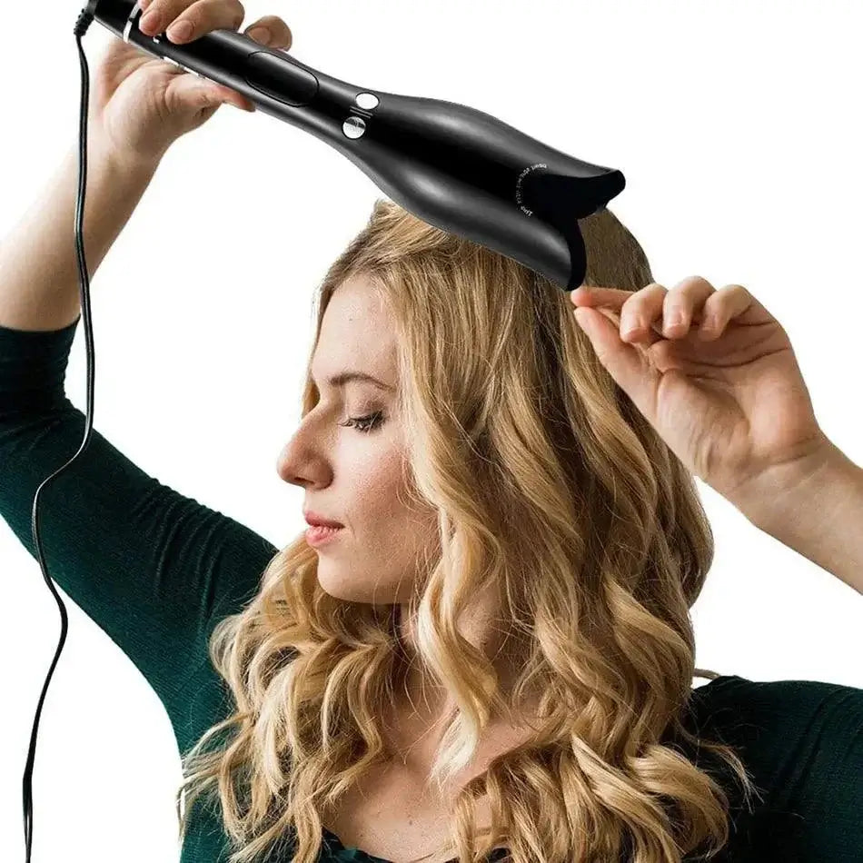Woman using PowerCurl® automatic curling iron for effortless, salon-quality curls at home.