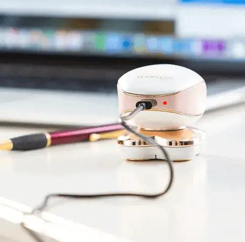Women Flawless Leg Hair Remover charging on desk.